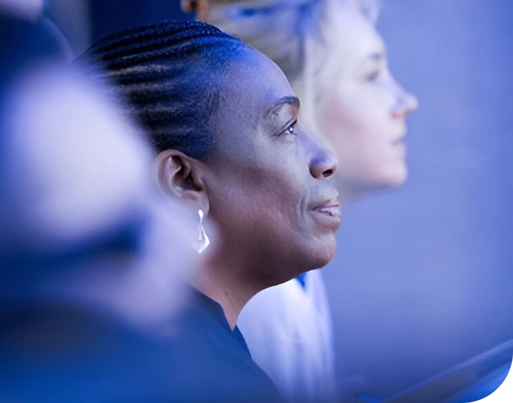 Woman with braids looking to the side.